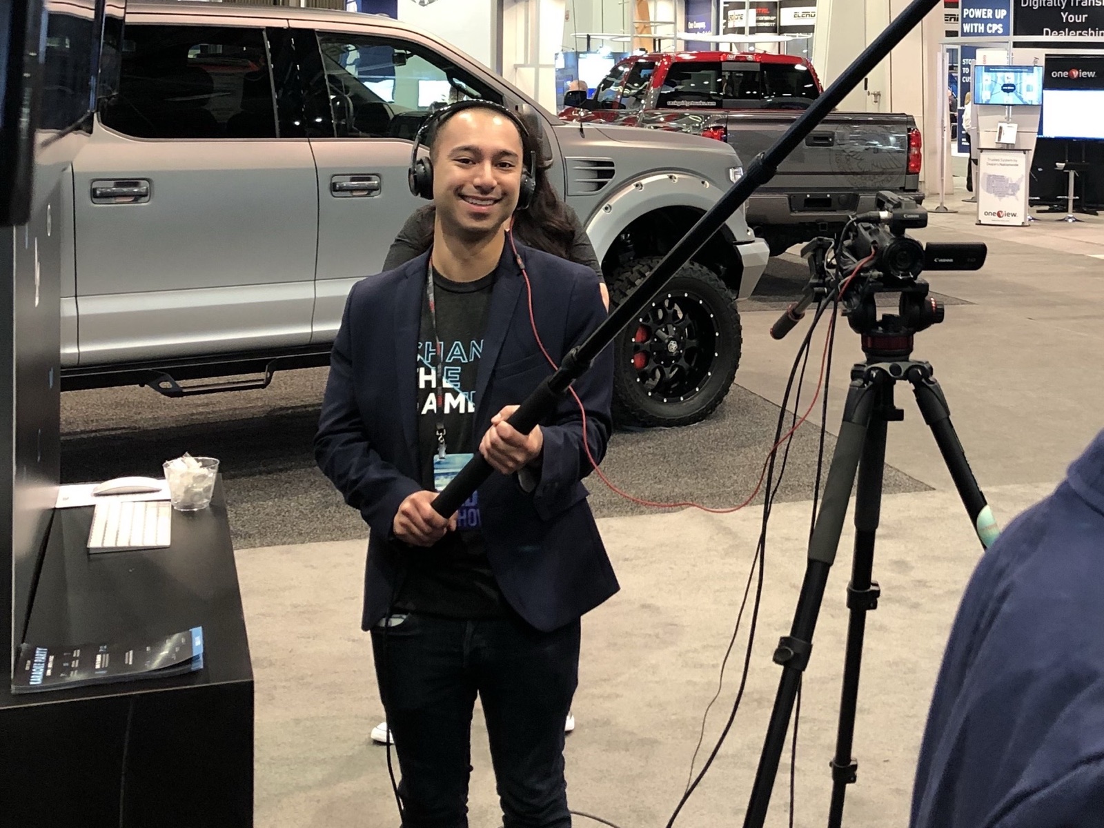 Eric Dumlao working at an automotive trade show